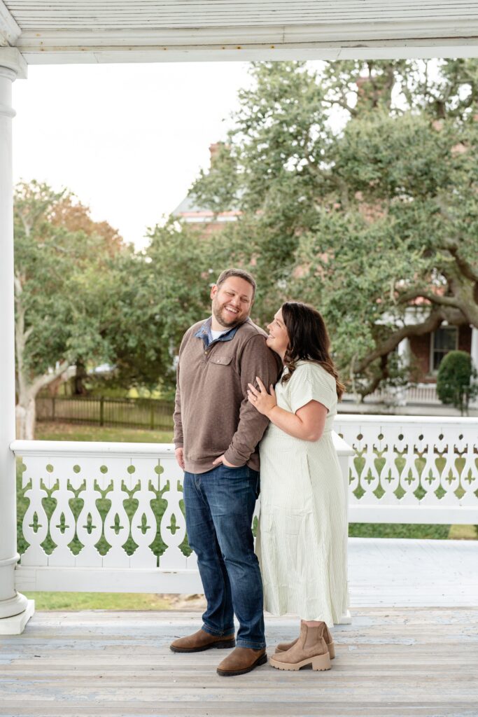 Woman standing behind man and smiling at each other