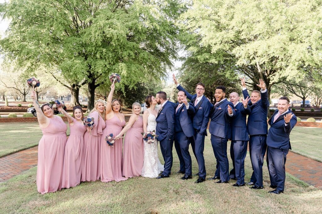 Blush bridesmaids dresses and navy suits in bridal photos