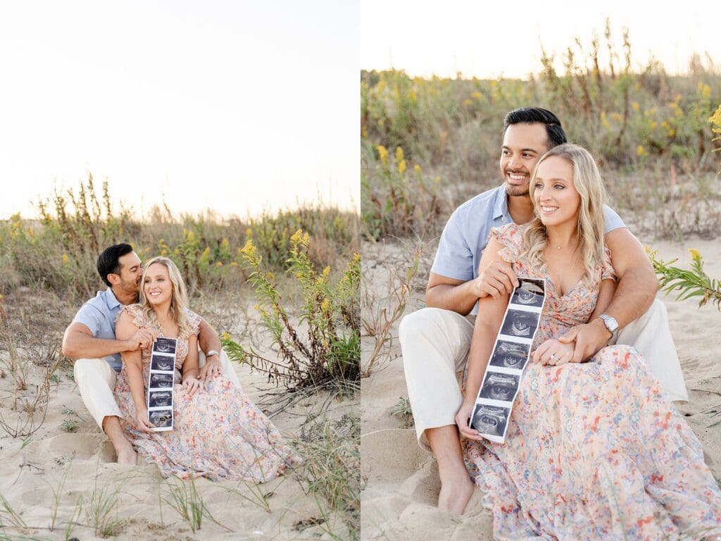 Payton and Jason holding ultrasound photos in sand