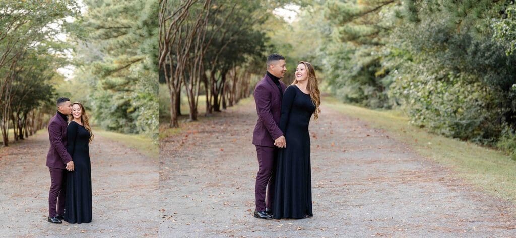 Couple walking along tree-lined path in formal black dress and purple suit