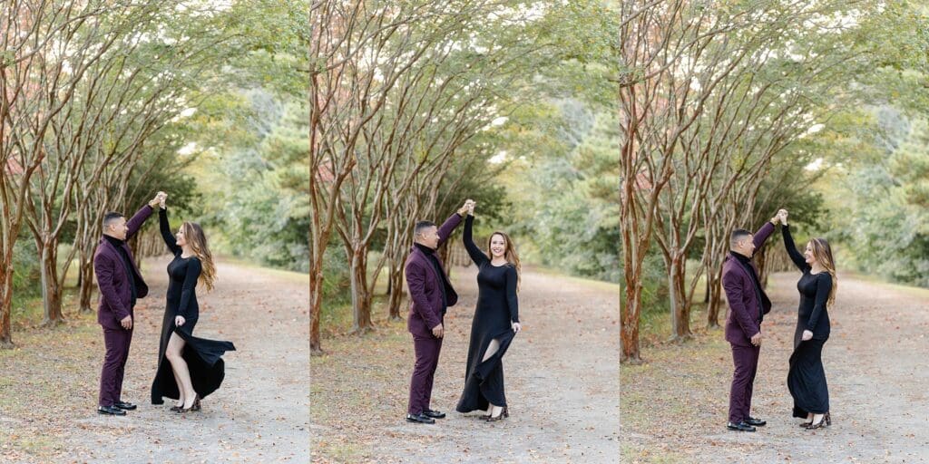 Couple walking along tree-lined path in formal black dress and purple suit