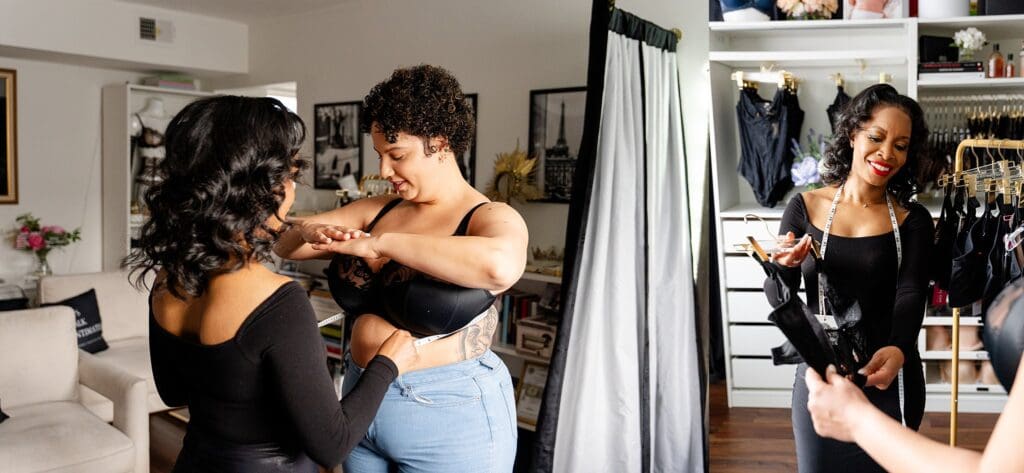 Nicole from Simone Cheríe Fine Lingerie offering a custom bra fitting during branding session