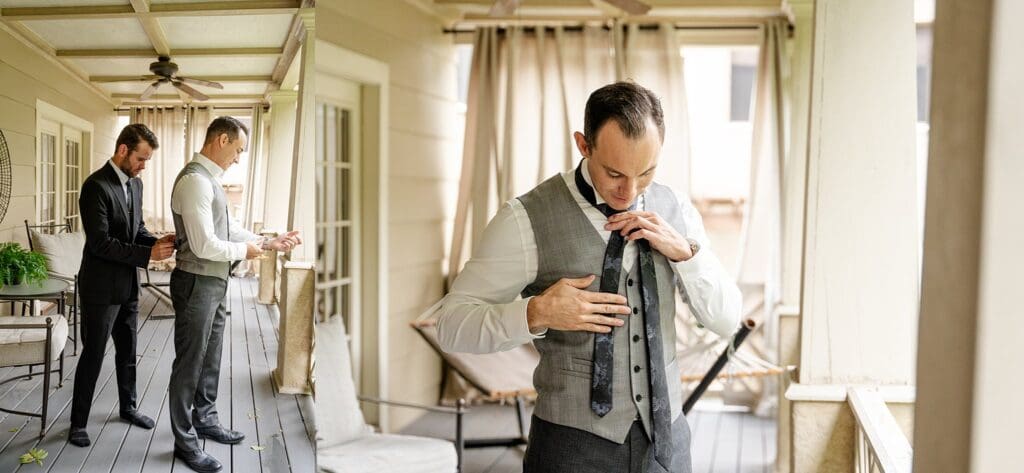 Groom getting ready on Pinner House porch