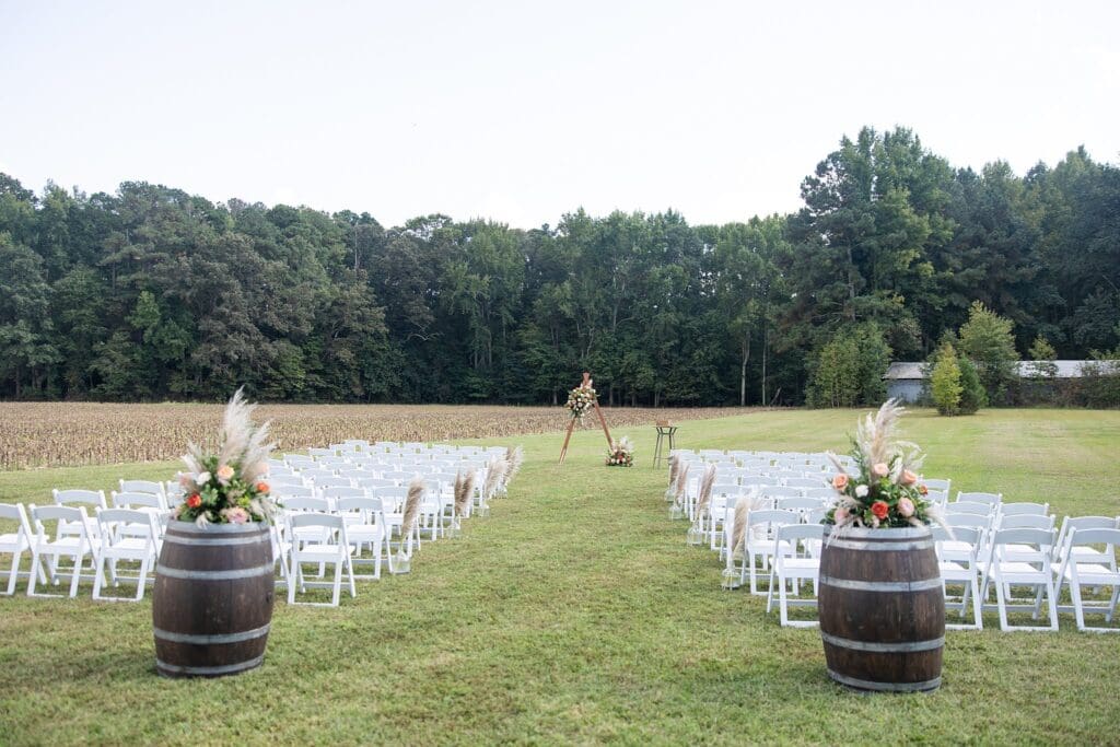 Ceremony outdoors char set up with flowers at The Barns of Kanak