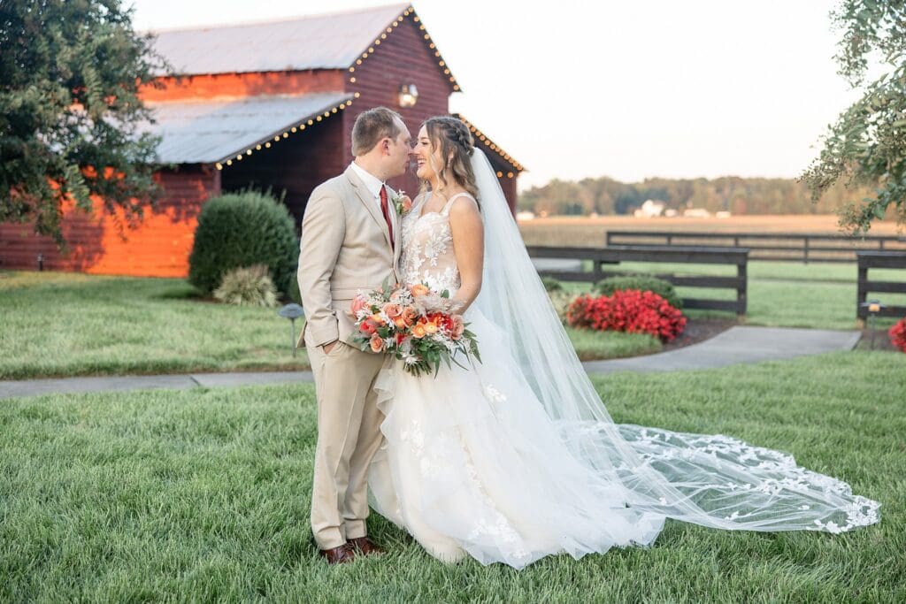 Romantic golden hour portraits with bride and groom by the barn