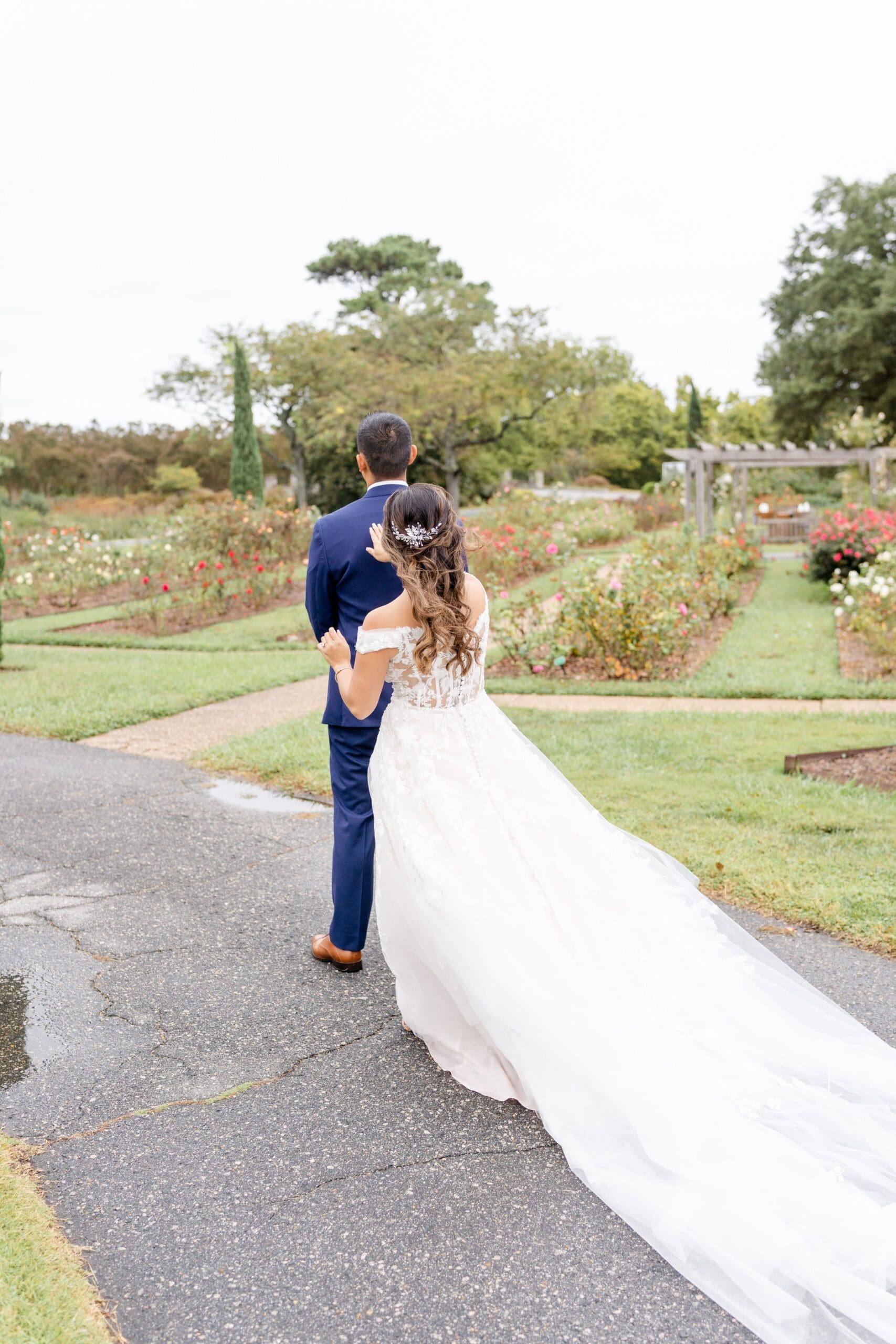 Bride standing behind groom at Norfolk Botanical Garden