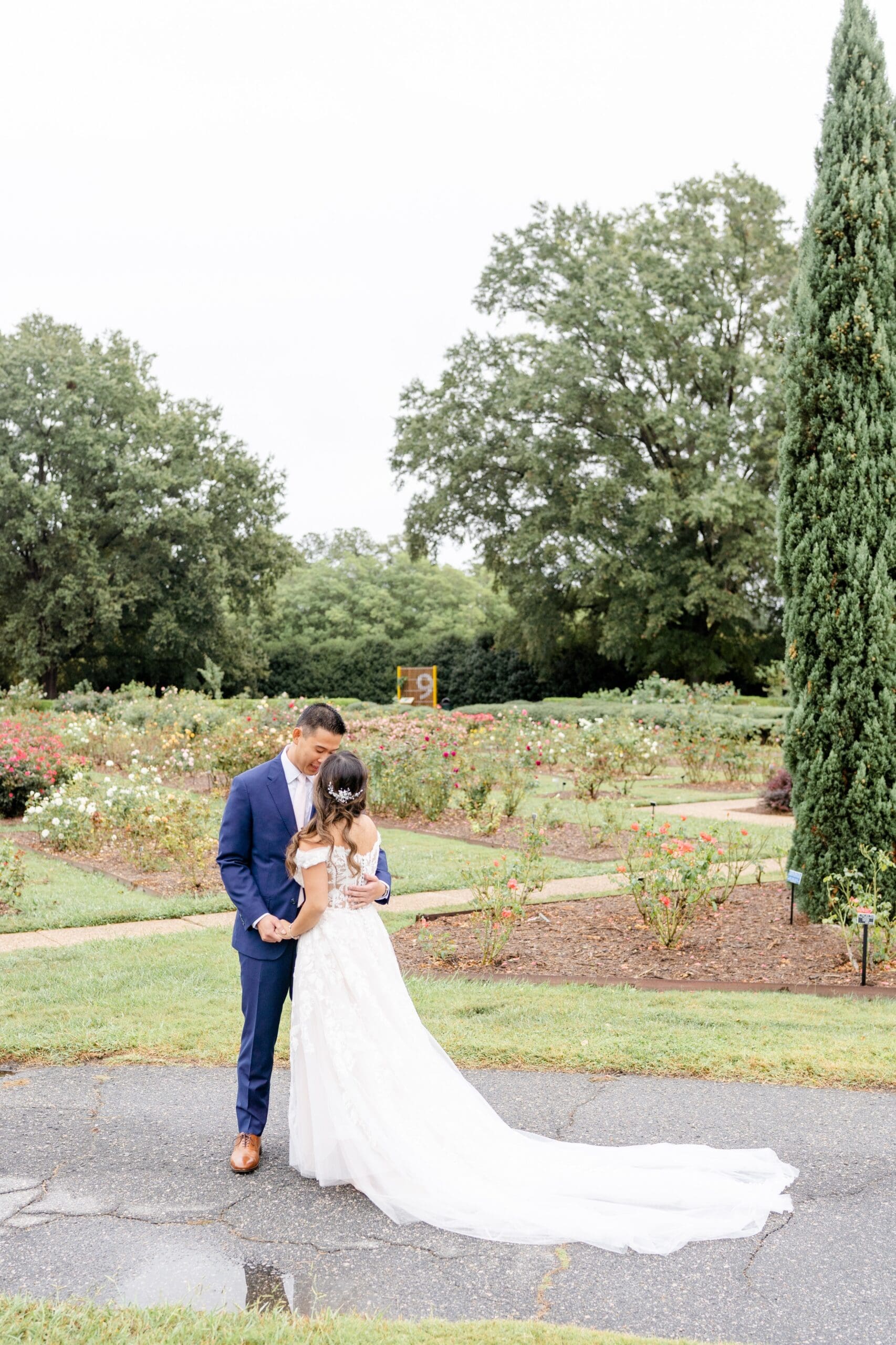 Bride and groom posing for Norfolk Botanical Garden wedding photos