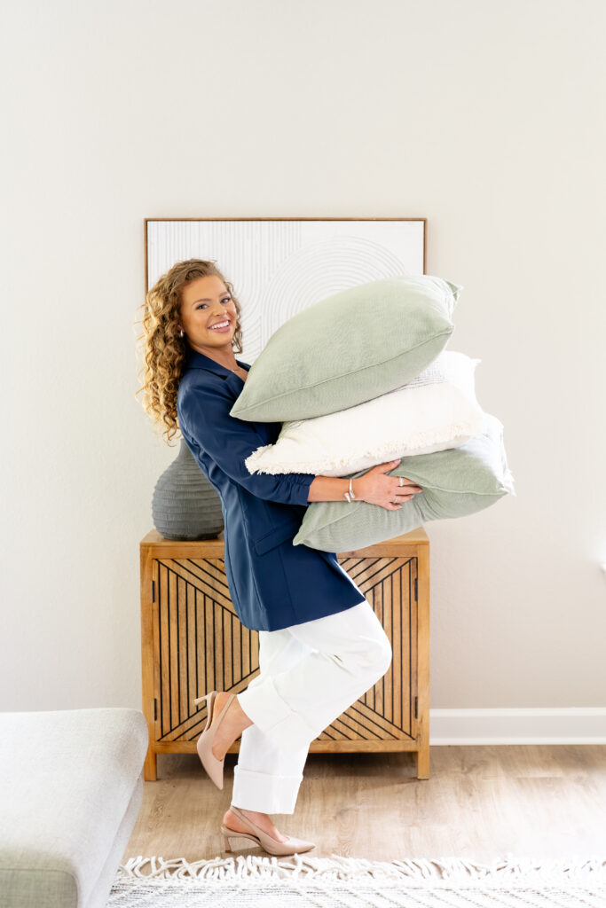 realtor holding pillows for branding photoshoot