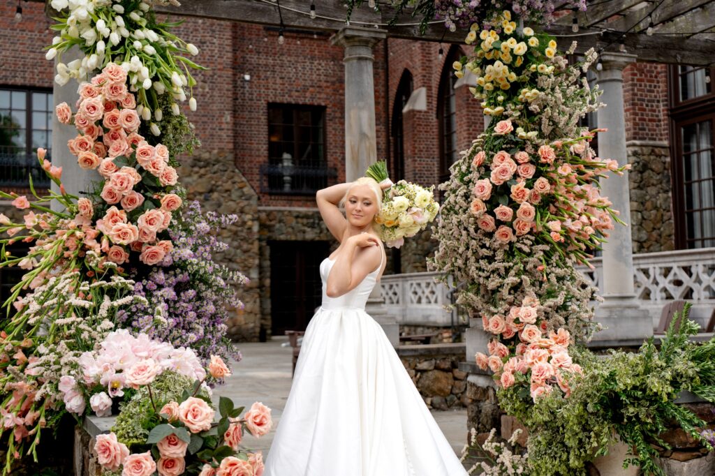 Bride holding flowers and posing for Dover Hall wedding photo
